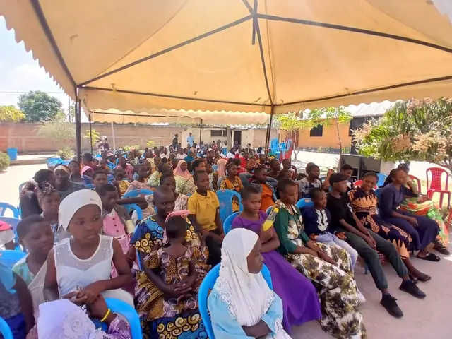 A community gathering under a tent