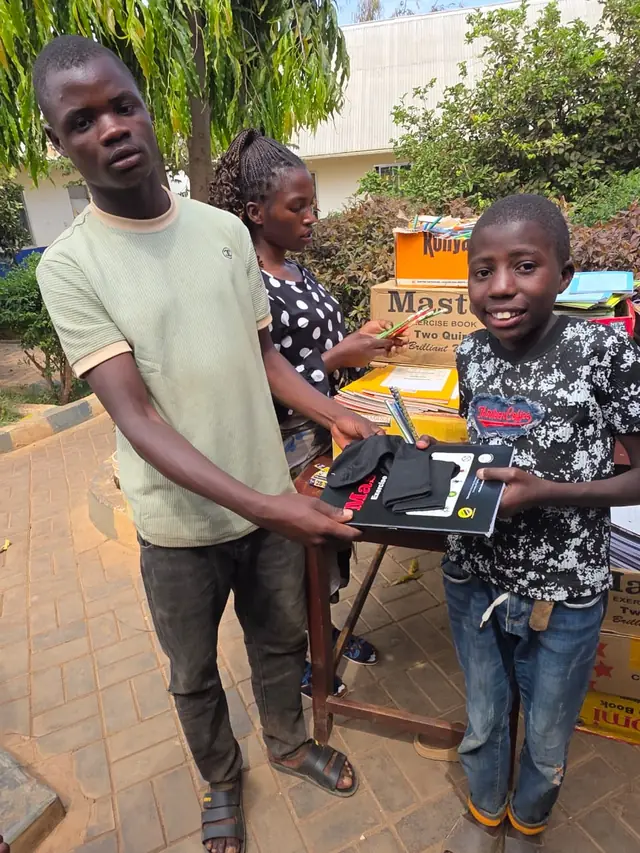 A boy receiving a new geometry set for school