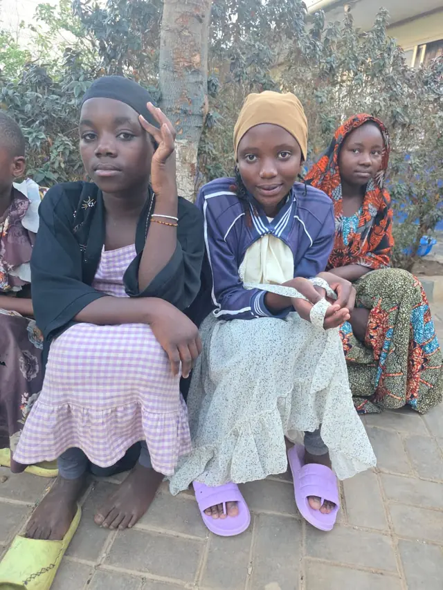 Girls sitting together outside